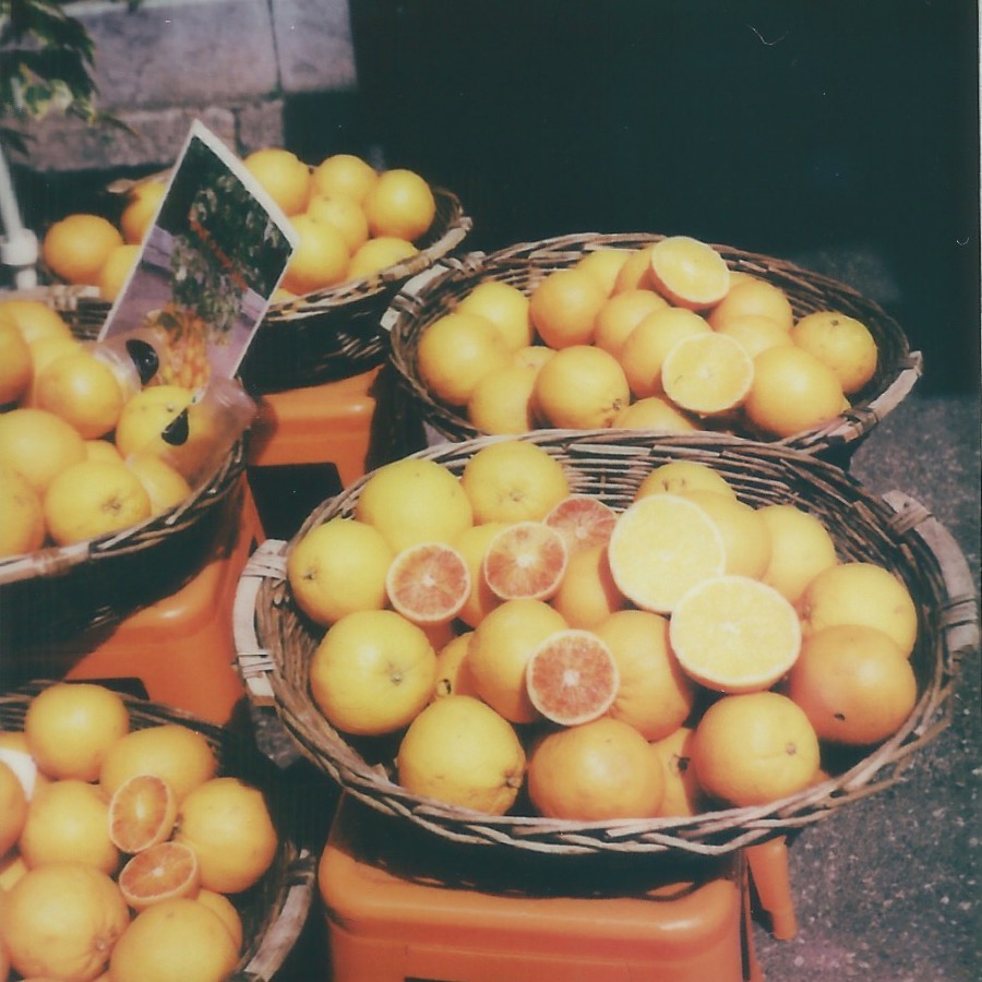 oranges on via teatro graco taormina, italy april 17, 2026 polaroid
