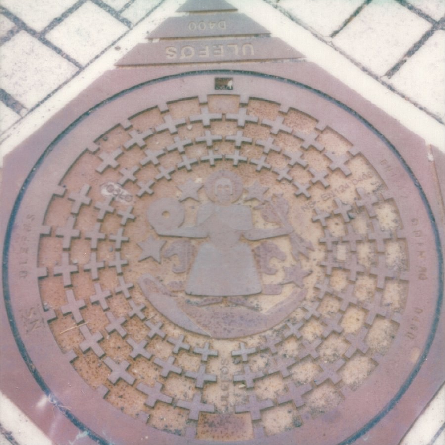 manhole cover (am i the only one that finds “manhole” to be the weirdest word?) oslo, norway august 17, 2026 polaroid